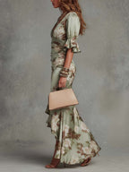 Anna - Asymmetrical long dress in green satin with V-neck, flared puff sleeves, and floral pattern